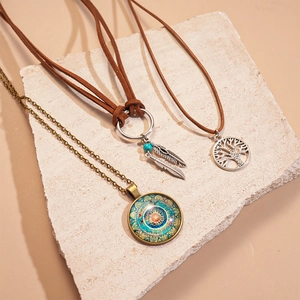 Three-piece bohemian necklace set with feather leaf and tree of life charms on stone