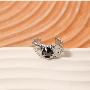 Close-up of silver lava-textured open ring with a faceted black gemstone inlay