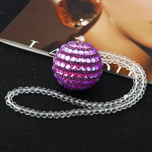 Detail of purple rhinestone car mirror pendant with elegant faceted transparent beads