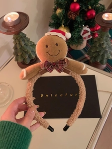 Detailed view of plush gingerbread man Christmas headband with lamb wool texture