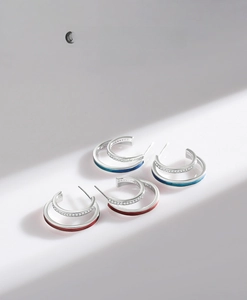 Detail of S925 silver C-shape earrings with colorful enamel lines and zircon stones