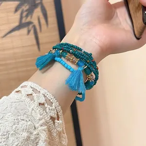 Bohemian multi-layer crystal beaded bracelet set with blue tassels and gold accents
