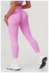 Detail view of pink high-waist seamless yoga pants showing peach butt lift and ribbed waistband