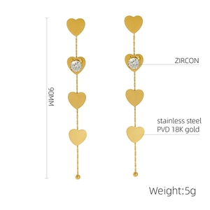 Detailed view of 90mm long stainless steel heart earrings with gold PVD and zircon