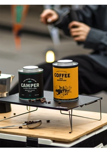 Outdoor camping coffee canisters with airtight metal lids and adventure graphic prints