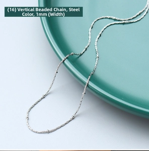 Close-up of a 1mm silver-tone stainless steel square bead chain on a green ceramic plate