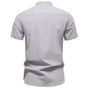 Detail of light grey cotton linen shirt back view featuring yoke and fabric texture