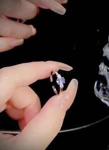 Macro shot of silver ring with purple zircon stones and adjustable floral design