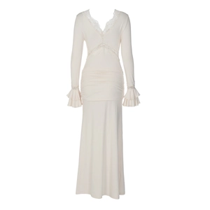 Detail of V-neck lace patchwork and layered ruffle sleeves on creamy white dress