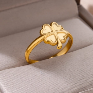 Macro view of gold 18k clover ring with four heart-shaped petals in velvet box