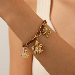 Bracciale in acciaio inossidabile dorato con cordino in velluto, fiore di perle e farfalla