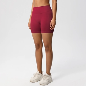 Detail of burgundy seamless high-waist yoga shorts with supportive ribbed compression band
