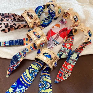 French retro open cuff bracelet featuring gold embossed metal and printed silk scarf wrap