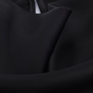 Close-up of premium black satin fabric showing smooth texture and elegant drape