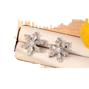 Elegant snowflake stud earrings in silver copper with zircon stones on display