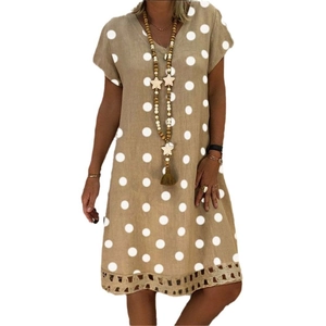 Detail of V-neck khaki polka dot midi dress showing intricate hollow-out embroidery hem