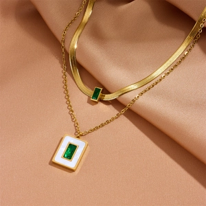 Double-layered gold necklace set with square green zircon and white enamel pendant