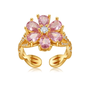 Detailed macro view of pink pear-cut stone flower ring with gold plating and zircons