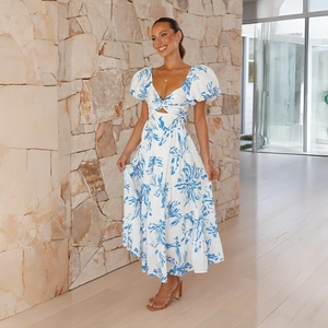 Detail of blue floral maxi dress featuring puff sleeves and waist cutout design