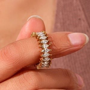 Close-up of gold eternity ring featuring marquise-cut clear zircons on a model hand