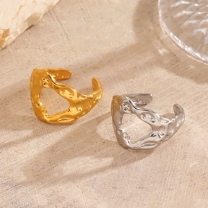 Irregular hammered 18K gold plated hollow heart ring for women on stone background