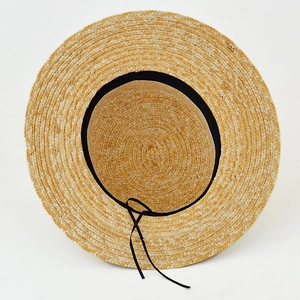 Handwoven straw boater hat with a flat brim and black ribbon tie for outdoor travel