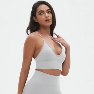 Detail of high-stretch light grey seamless yoga set showing V-neck crop top and leggings