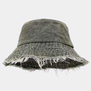 Close-up detail of distressed frayed edges on a vintage washed denim bucket hat