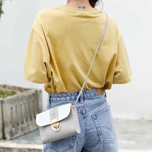Women's gray and white color-block crossbody square bag with gold buckle on model