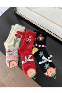 Detailed view of three mink velvet socks in beige, red and black with cute floral patterns