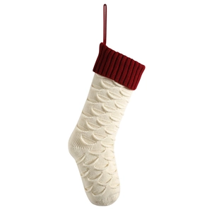Cream knit Christmas stocking with fish scale pattern and dark red ribbed cuff decoration