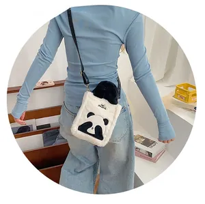 Close-up of cute plush panda crossbody bag with embroidered logo and black slim strap