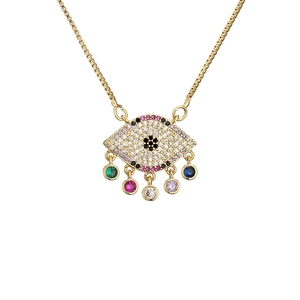Gold eye pendant necklace with colorful zircons on white background