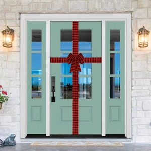 Close-up of a red and black buffalo plaid ribbon and large bow on a front door