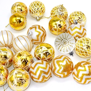 Detailed view of 6cm gold and white Christmas balls with glitter star and wave patterns