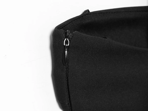 Detail of invisible zipper closure and high-density black knit fabric on long dress