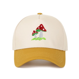 Detailed close-up of mushroom embroidery on a two-tone cotton baseball cap with curved brim