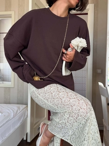 Oversize dark brown long sleeve crewneck sweatshirt styled with white lace trousers