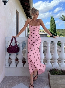Detail of pink and brown polka dot maxi dress featuring an open back with lace-up ties