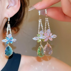 Detailed view of long earrings featuring colorful zircon flowers and teardrop crystal drops