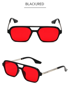 Close-up of retro square aviator sunglasses with black frames and vibrant red lenses