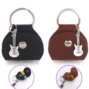 Detail of leather guitar pick holder keychain with metal guitar pendant and snap button