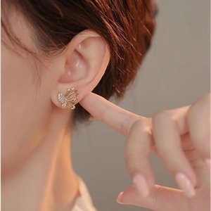 Elegant gold butterfly stud earring with micro-paved zircons and hollow wing design