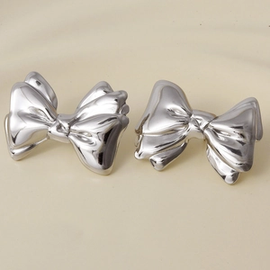 Detailed view of 304 stainless steel bow earrings with high-polish silver mirror finish