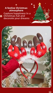 Detail view of Christmas reindeer headbands with snow patterns, feathers and gold bells
