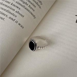 Vintage 925 sterling silver adjustable ring with oval black agate on book background