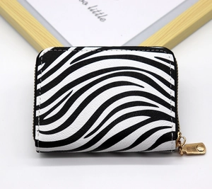 Close-up of zebra pattern zipper wallet made of premium PU leather with gold metal hardware