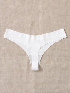 Close-up of white seamless thong featuring laser-cut edges and cotton gusset detail