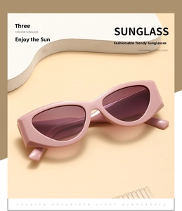 Close-up of pink thick-frame cat-eye sunglasses with gradient purple polarized lenses