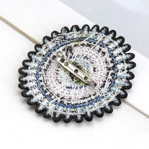 Detailed back view of embroidered Evil Eye brooch with secure metal safety pin closure